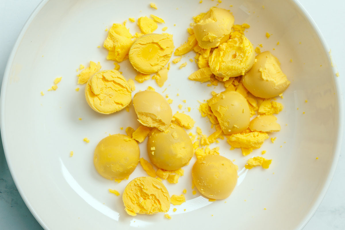 Hard boiled egg yolks in a white bowl.