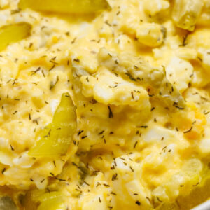 Egg salad with sliced dill pickle chips.