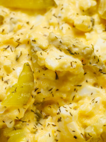 Egg salad with sliced dill pickle chips.